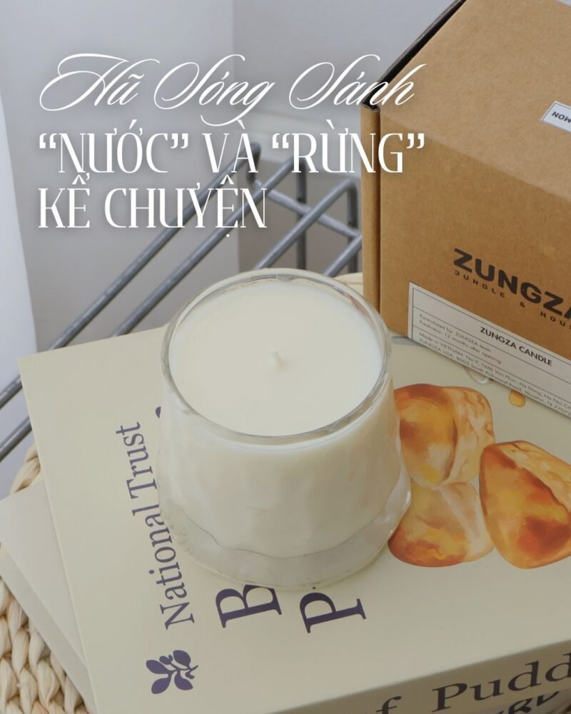 ZUNGZA Song Sanh glass candle burning on a table — Choosing scents by season in Vietnam