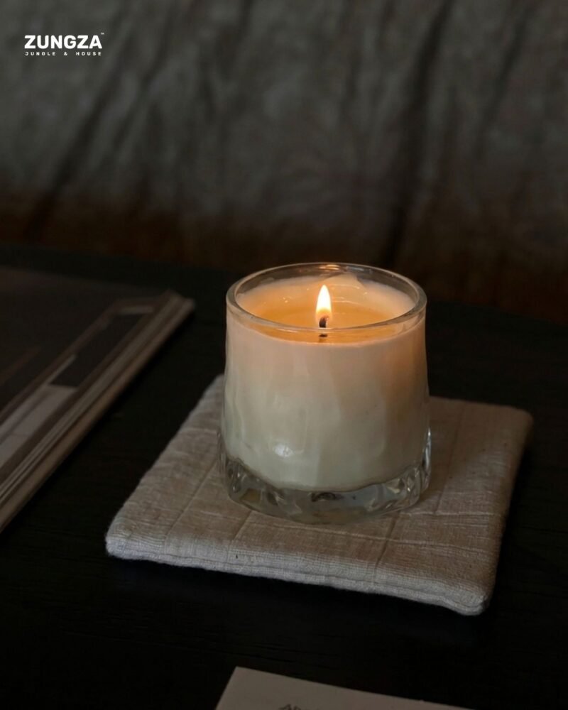 ZUNGZA Song Sanh glass candle burning on a table — The reading corner and one small flame