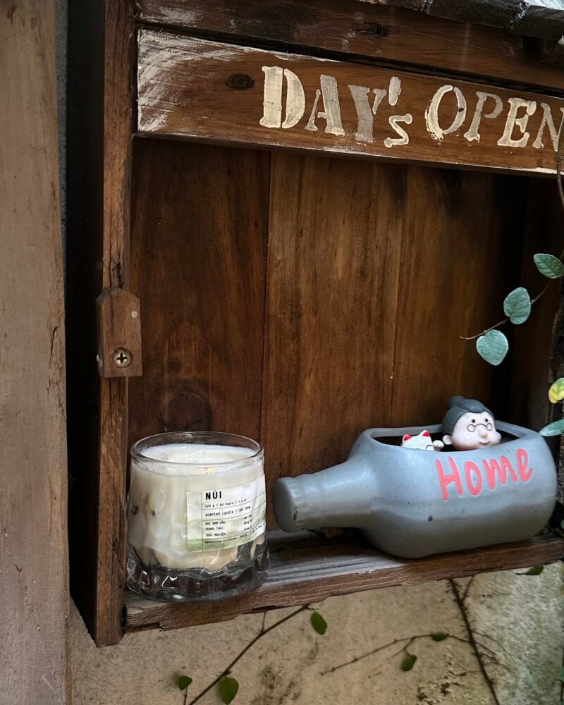 A ZUNGZA glass candle jar among green leaves — Two bottles of perfume and two kinds of person