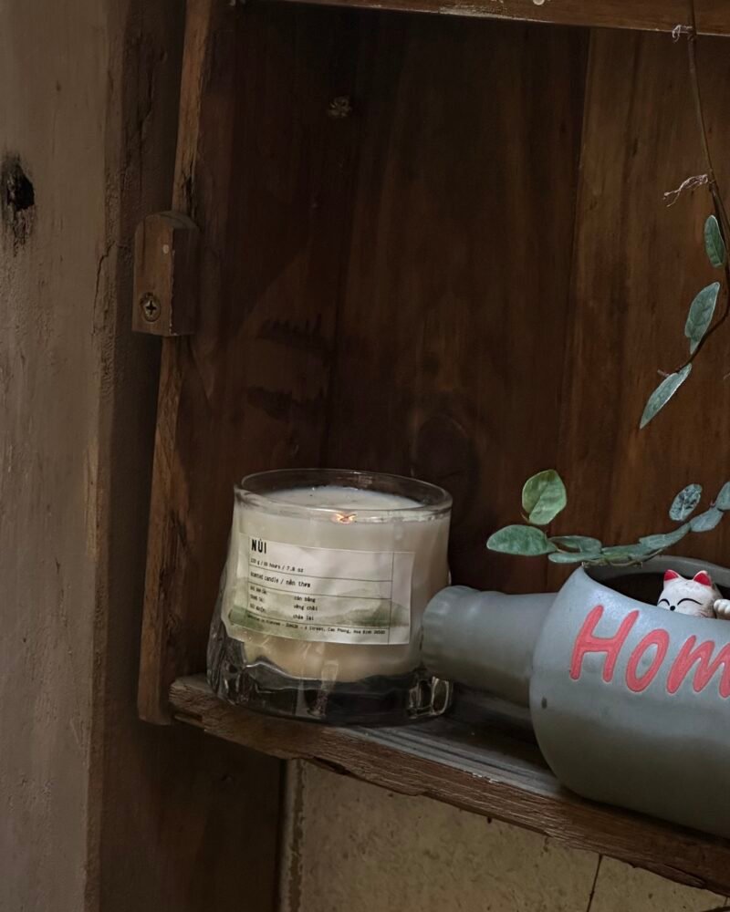 A ZUNGZA glass candle jar among green leaves — Hoa Binh, the small stream and the way to ZUNGZA