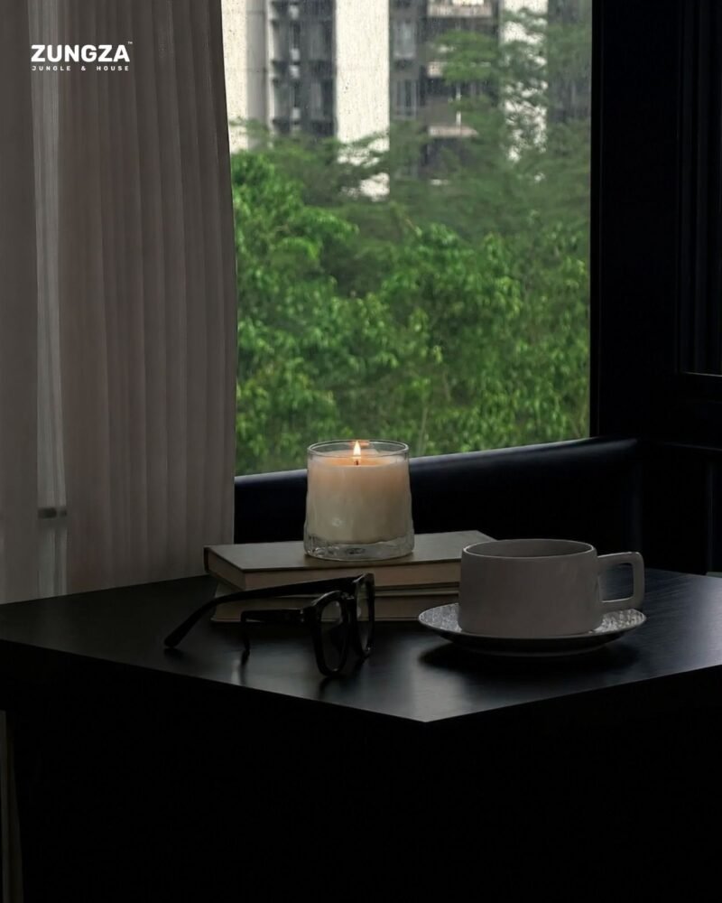 ZUNGZA Song Sanh glass candle burning on a table — Scent for a homestay and a small café